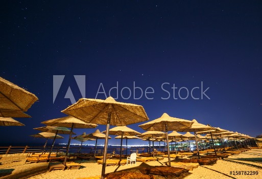 Picture of sunshade beach umbrellas against night sky in Egypt